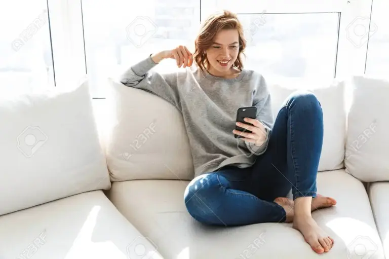 woman distracted by smartphone indoors