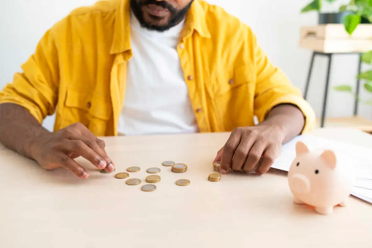 young person counting coins saving money