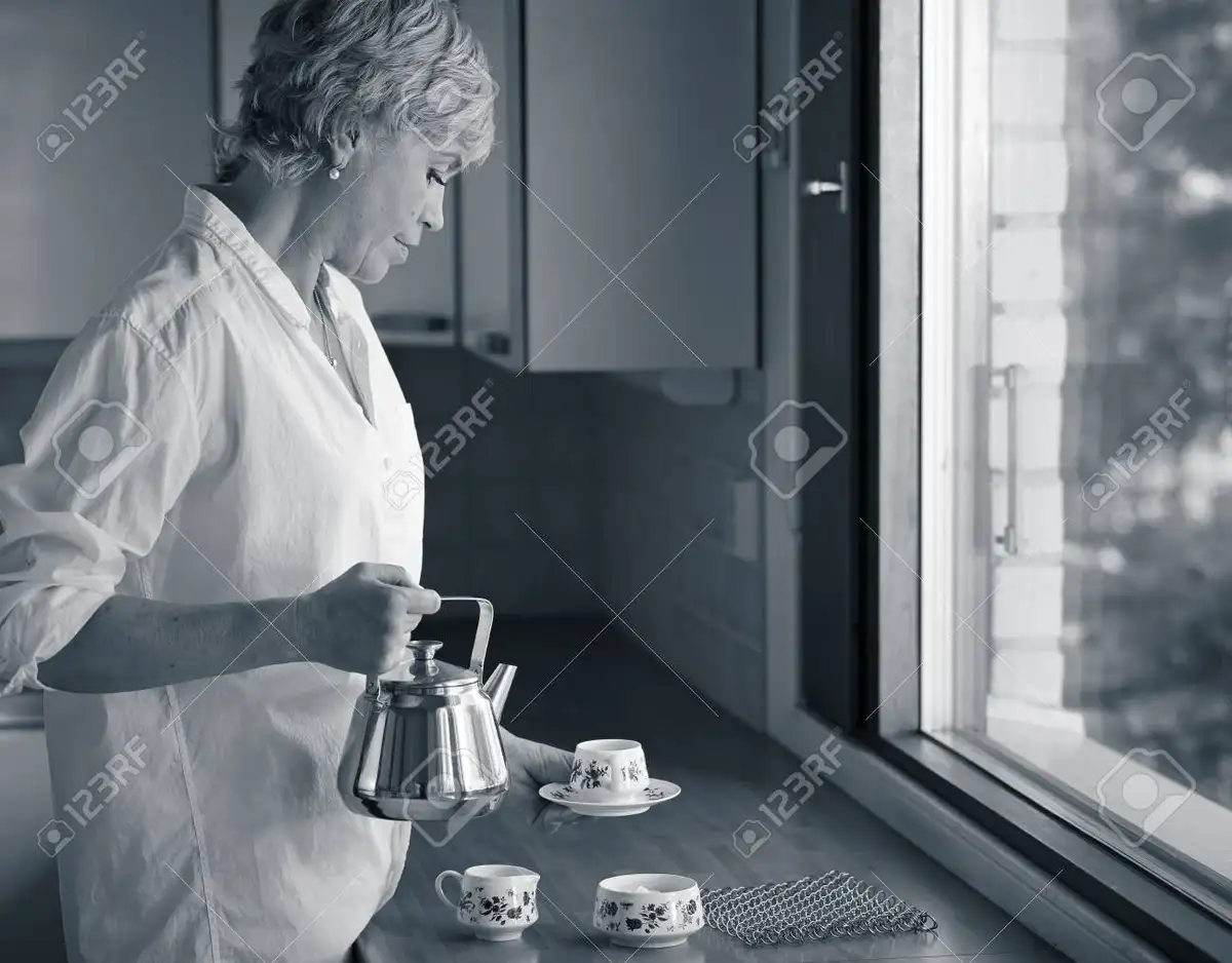 woman enjoying morning green tea kitchen sunlight