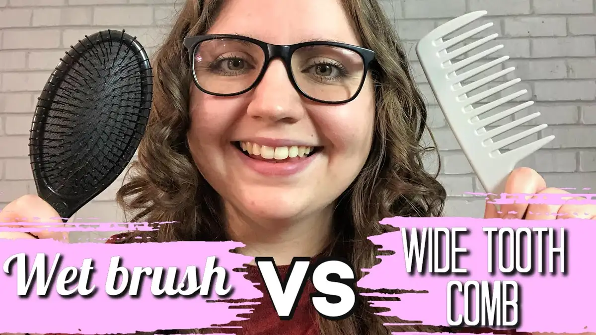 close up detangling wet hair with wide tooth comb bathroom