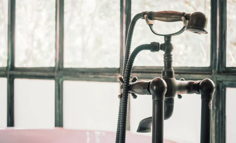 close up of stubborn limescale stains in modern bathroom, dynamic angle