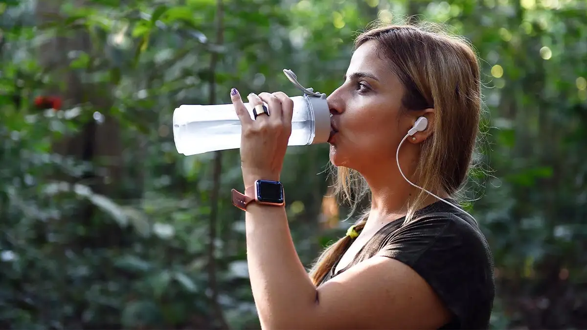 woman walking in park headphones healthy mind memory boost