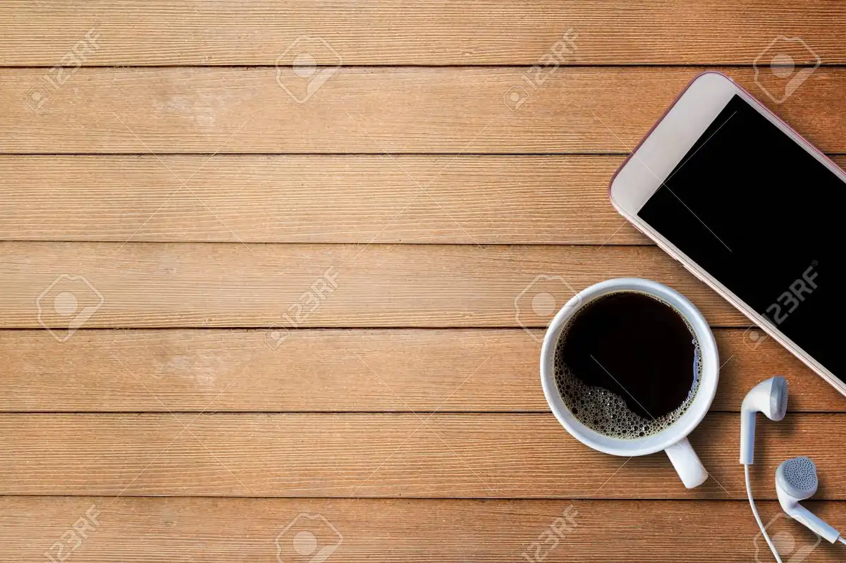 smartphone screen with ETF chart and coffee on a wooden desk