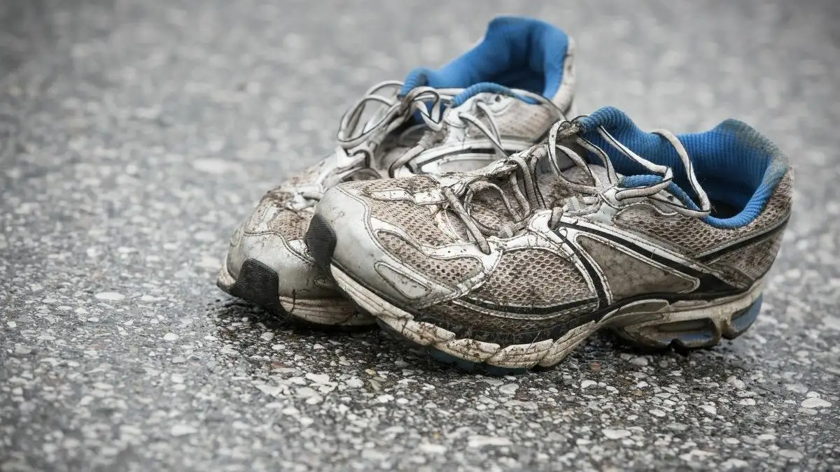 worn running shoes restoration on table