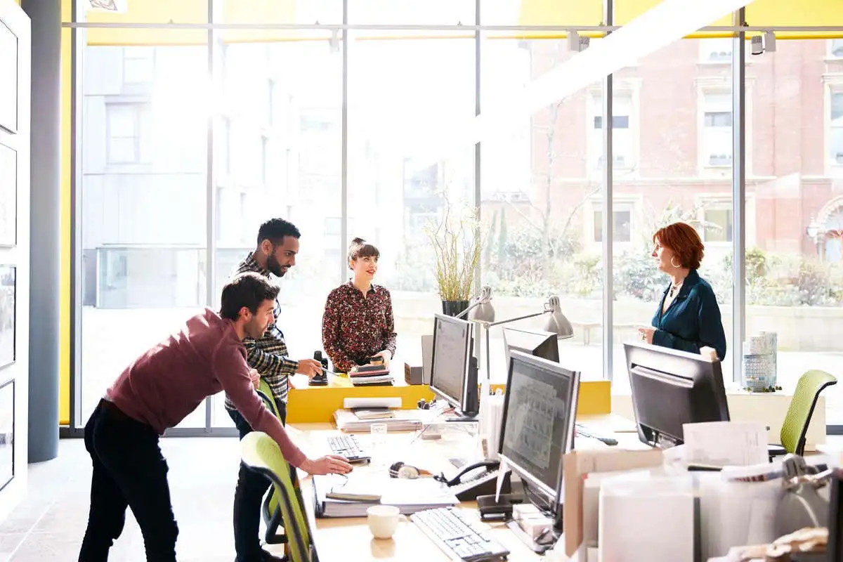 confident solo worker modern workspace sunlight