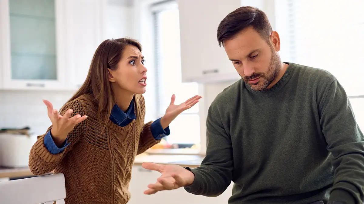 realistic couple discussing conflict resolution at home