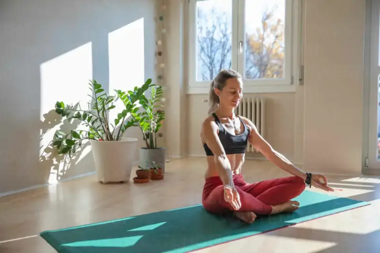 smiling senior woman doing yoga at home sunny